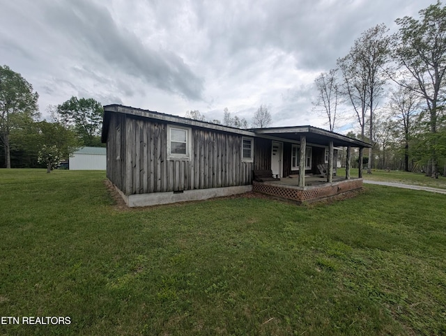 view of front facade featuring covered porch, board and batten siding, and a front lawn