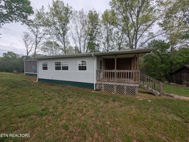 rear view of house featuring a yard