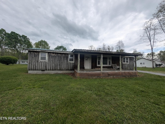 view of front of house with covered porch, board and batten siding, and a front yard