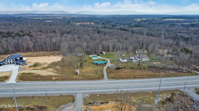 aerial view featuring a mountain view and a forest view