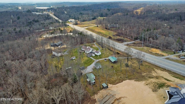 birds eye view of property featuring a wooded view