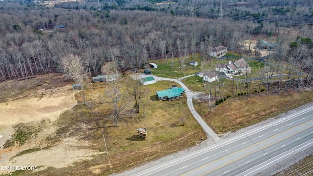 drone / aerial view with a wooded view