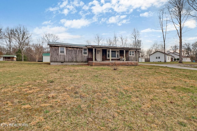 view of front of home featuring a porch, crawl space, and a front yard