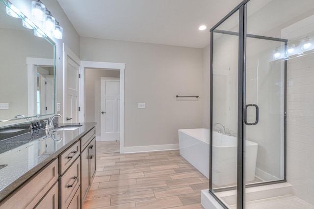 full bathroom with recessed lighting, a shower stall, a sink, and wood tiled floor