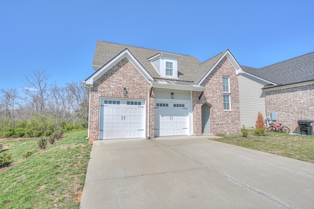 view of front facade featuring a garage, driveway, a front lawn, and brick siding