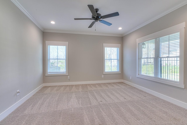 spare room featuring crown molding, recessed lighting, baseboards, and light colored carpet