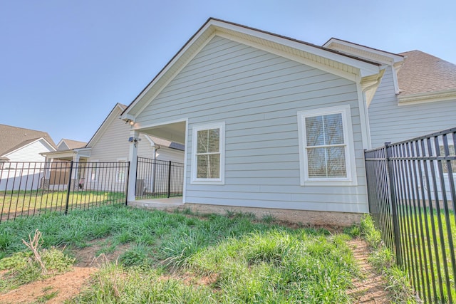 view of side of property featuring fence