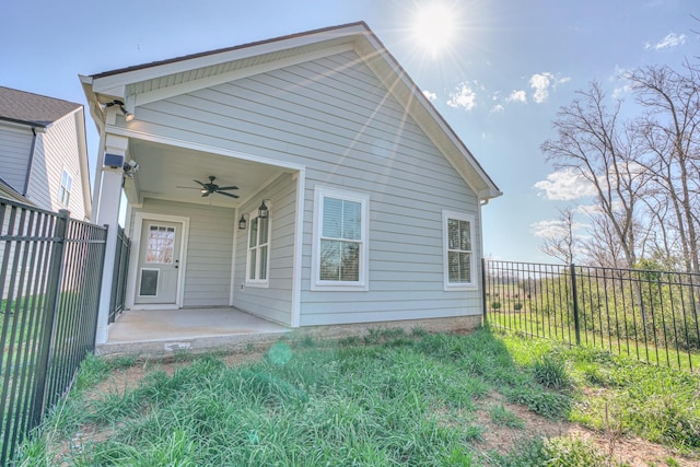 back of house featuring ceiling fan and a fenced backyard