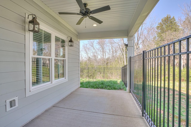 view of patio featuring fence and ceiling fan