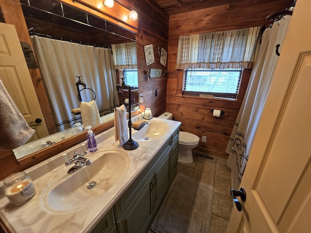 full bathroom featuring a sink, toilet, and wood walls
