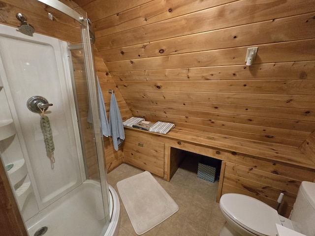 full bathroom featuring tile patterned flooring, a stall shower, wooden walls, and toilet