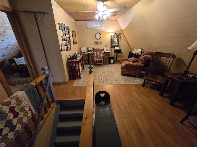 interior space with wooden ceiling, a wall mounted air conditioner, and wood finished floors