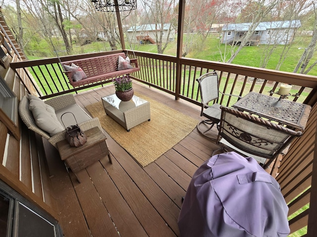 wooden terrace with a lawn, an outdoor living space, and an outbuilding