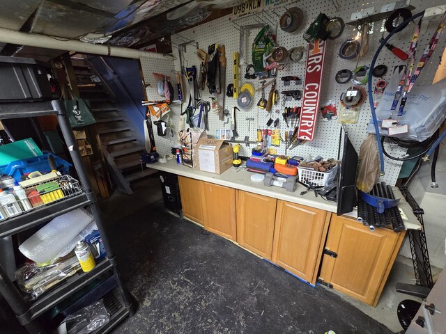 misc room with a workshop area and concrete flooring