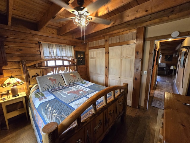 bedroom with wood ceiling, beamed ceiling, wood walls, and dark wood-style floors