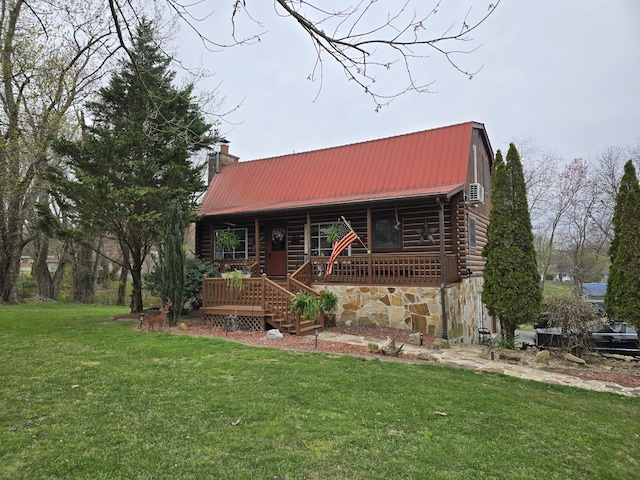 log cabin with covered porch, metal roof, a chimney, and a front lawn