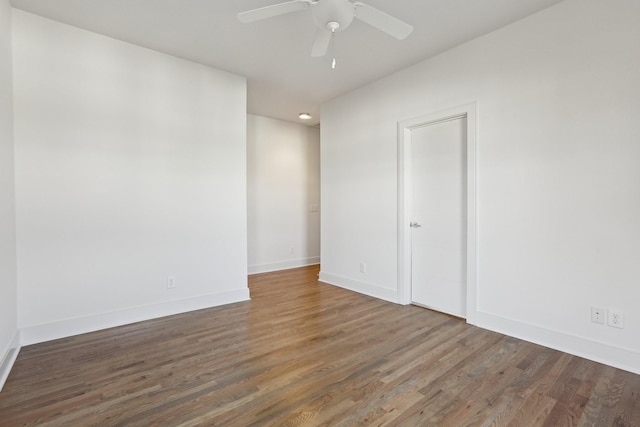 unfurnished room featuring baseboards, ceiling fan, and wood finished floors
