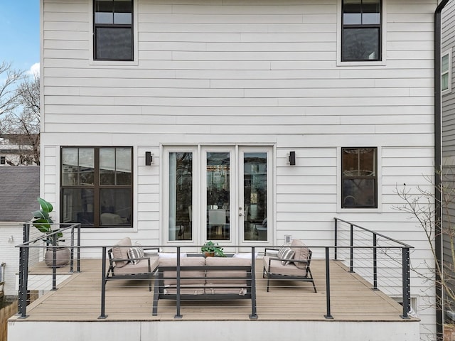 back of property with french doors, a wooden deck, and an outdoor hangout area