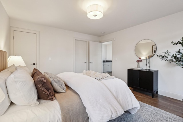 bedroom featuring baseboards and wood finished floors