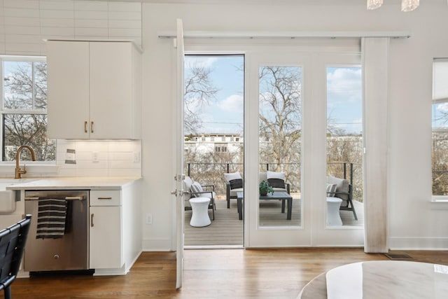 entryway featuring beverage cooler, dark wood-style floors, and plenty of natural light