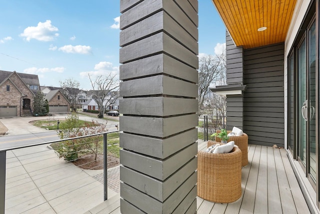 wooden terrace with driveway and a residential view