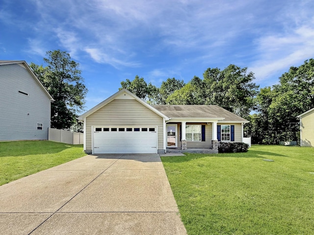 ranch-style house with a garage, fence, driveway, and a front yard