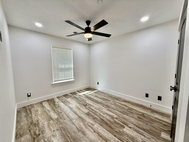 spare room featuring baseboards, ceiling fan, recessed lighting, and wood finished floors