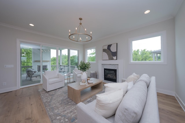 1052 Wetzel Dr, Franklin, TN 37064 - living room featuring ornamental molding, a premium fireplace, recessed lighting, baseboards, and a chandelier