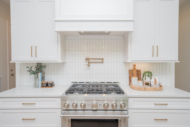 1052 Wetzel Dr, Franklin, TN 37064 - kitchen with high end stainless steel range, tasteful backsplash, light countertops, and white cabinets