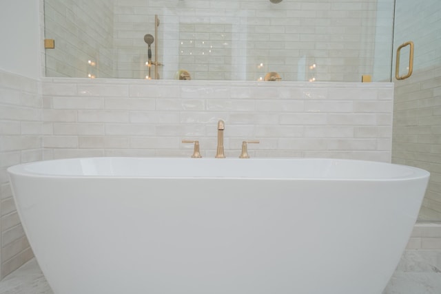 1052 Wetzel Dr, Franklin, TN 37064 - bathroom featuring tile walls, tiled shower, a freestanding tub, and marble look tiles