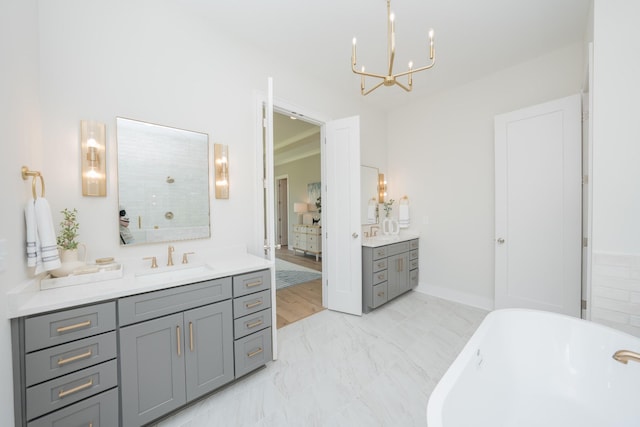 1052 Wetzel Dr, Franklin, TN 37064 - bathroom featuring two vanities, a chandelier, a soaking tub, marble look tiles, and a shower