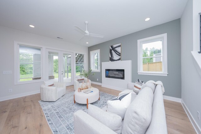 1052 Wetzel Dr, Franklin, TN 37064 - living area featuring french doors, light wood finished floors, recessed lighting, ceiling fan, and baseboards