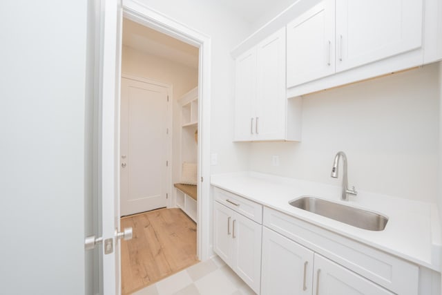 1052 Wetzel Dr, Franklin, TN 37064 - kitchen with a sink, white cabinetry, light countertops, and light flooring