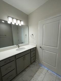 bathroom featuring marble finish floor and vanity