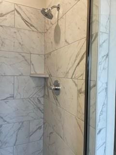 interior details featuring a stall shower