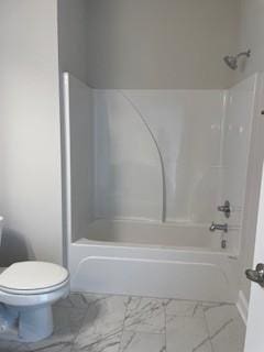 bathroom with toilet, shower / tub combination, and marble finish floor