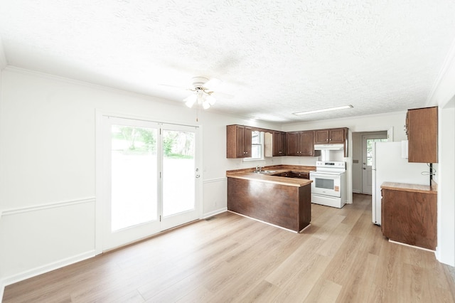 kitchen with a peninsula, white appliances, light wood-style floors, under cabinet range hood, and a ceiling fan