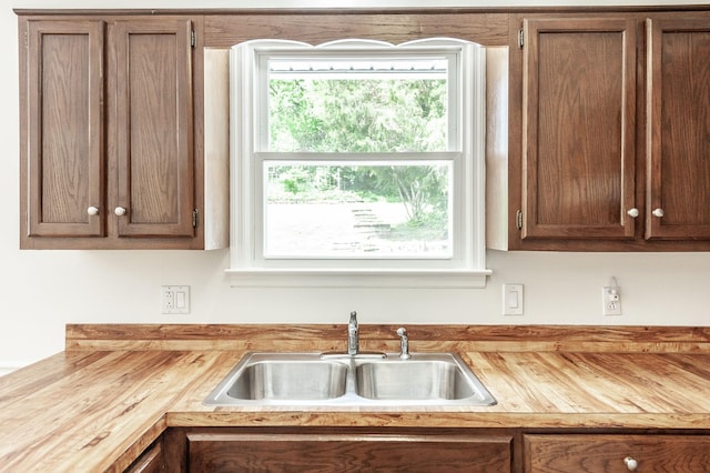 kitchen with butcher block countertops and a sink