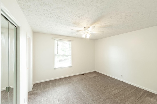 unfurnished bedroom featuring a closet, carpet flooring, baseboards, and a textured ceiling