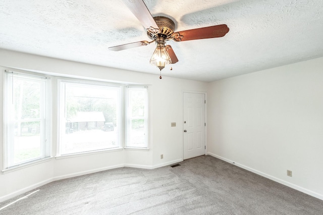 unfurnished room featuring carpet floors, baseboards, and a healthy amount of sunlight