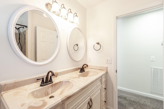 bathroom featuring a sink, double vanity, and visible vents
