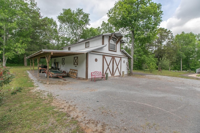 exterior space featuring aphalt driveway and a garage