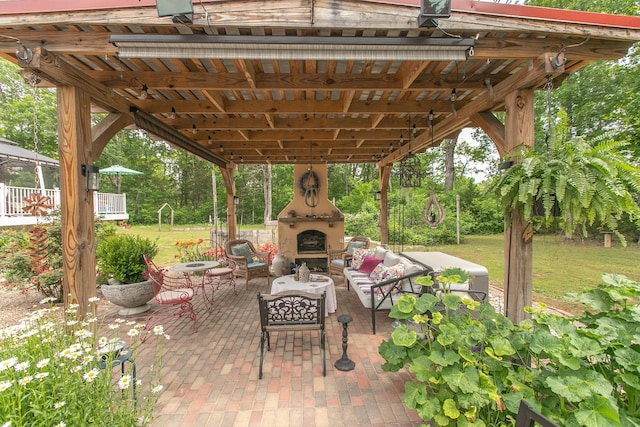 view of patio featuring an outdoor living space with a fireplace