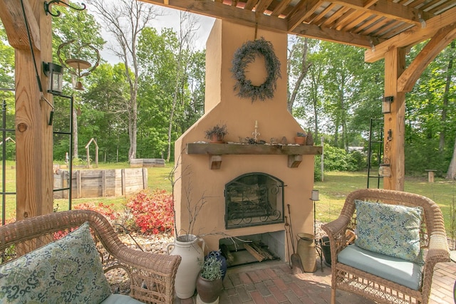 view of patio with exterior fireplace