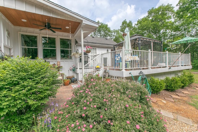 exterior space with a wooden deck and a ceiling fan