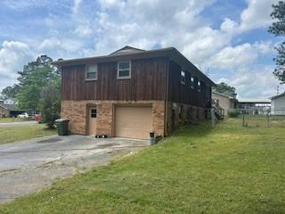 1708 Deer Hollow Dr, Lawrenceburg, TN 38464 - view of property exterior featuring concrete driveway and an attached garage