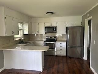 1708 Deer Hollow Dr, Lawrenceburg, TN 38464 - kitchen featuring stainless steel appliances, a sink, a peninsula, white cabinets, and light countertops