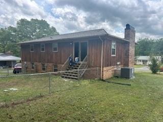 1708 Deer Hollow Dr, Lawrenceburg, TN 38464 - back of property featuring a chimney and central AC