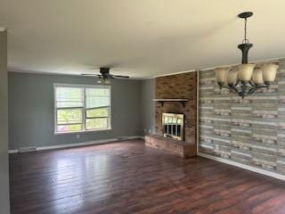 1708 Deer Hollow Dr, Lawrenceburg, TN 38464 - unfurnished living room featuring wood finished floors, ceiling fan, baseboards, a chandelier, and brick wall
