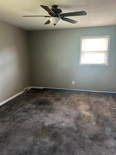 1708 Deer Hollow Dr, Lawrenceburg, TN 38464 - empty room featuring baseboards, dark carpet, and ceiling fan
